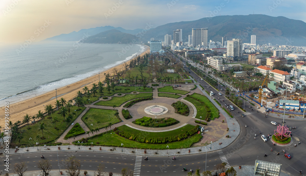 Αυτοκόλλητο Quy Nhon, Binh Dinh, Vietnam - A panoramic view of the city's coastline and urban landscape, showcasing the beach, palm trees, and busy streets with cars and motorbikes