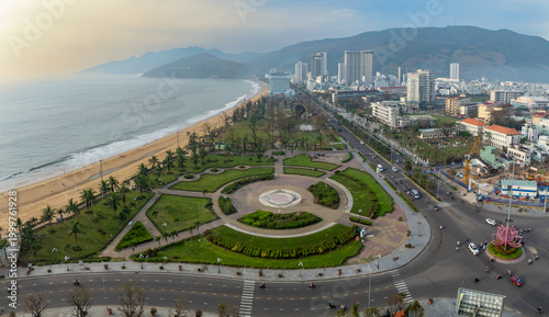 Εκτύπωση καμβά Quy Nhon, Binh Dinh, Vietnam - A panoramic view of the city's coastline and urban landscape, showcasing the beach, palm trees, and busy streets with cars and motorbikes