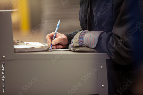 Labor worker writing in factory