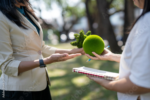 People exchanging green earth globe representing esg concepts