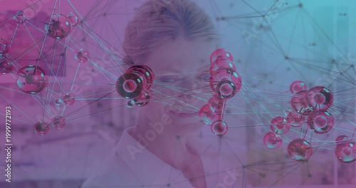 Posing scientist wearing white lab coat and specs behind 3D molecular net in lab, magenta-cyan glow