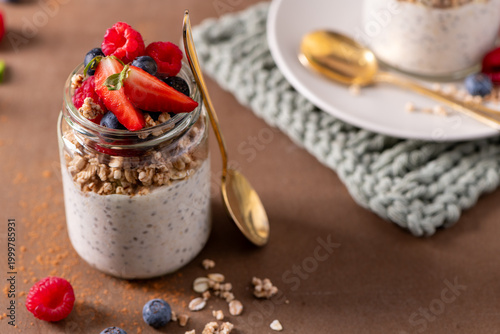 Overnight Oats or Chia Pudding with Fresh Berries and Granola in a Mason Jar