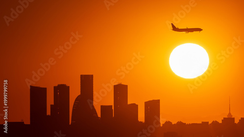 The Wangjing business buildings and aircraft industry in Beijing at sunset
