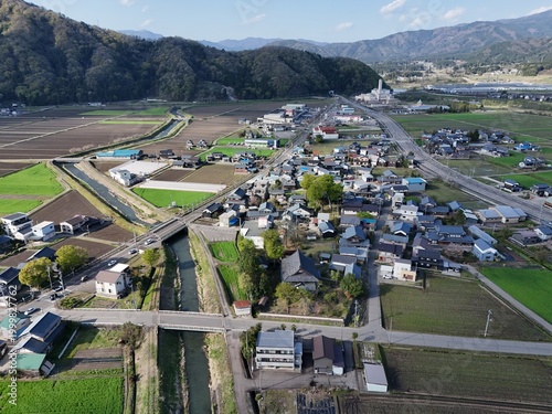 Aerial view of quiet countryside village with mountains in background