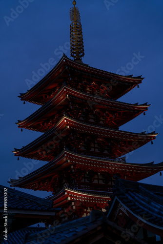 Illuminated Japanese pagoda temple at dusk in Tokyo, Japan
