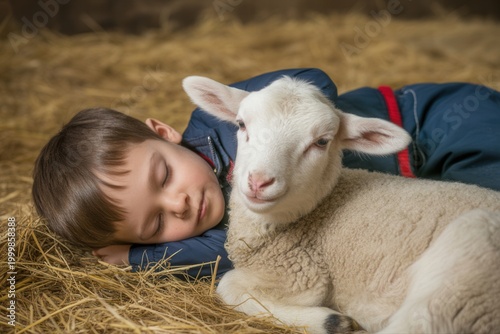 A young boy peacefully sleeps with a white lamb on hay in a rustic barn setting