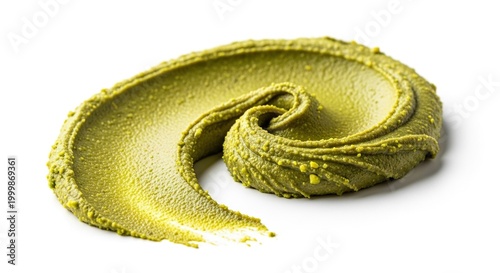 Thick swirl of decadent green pistachio nut butter spread artistically on a bright white backdrop, displaying rich texture and fresh color, pieces, emerald, vegetable