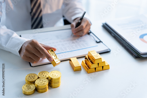 Businessman calculate gold price gold trading concept