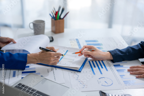 Business people analyzing financial report data on desk