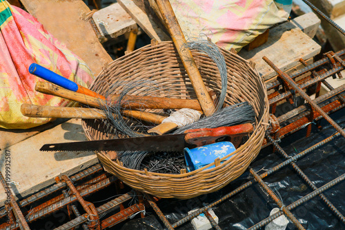 Construction Tools and Binding Wire in Wicker Basket on Work Site