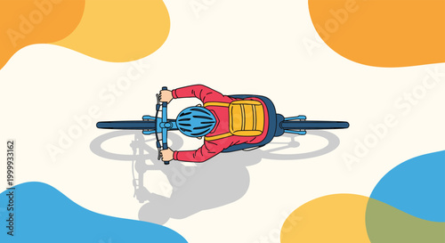 Aerial view of a cyclist wearing a helmet and a red jacket riding a blue bicycle across a light surface decorated with colorful abstract blobs.
