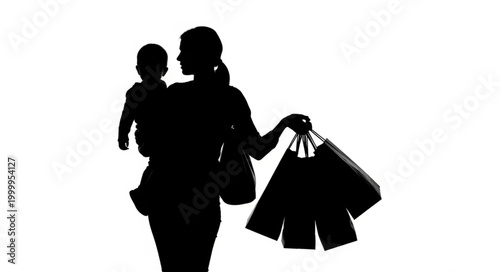 Silhouette of a mother carrying her baby and shopping bags.