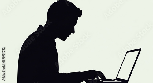 Silhouette of a person intensely focused on a laptop screen.