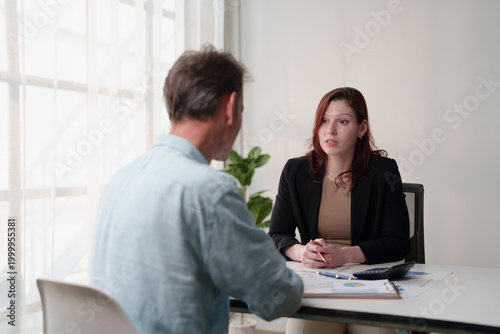Tableau sur toile Businesswoman advising man during financial consultation appointment, discussing