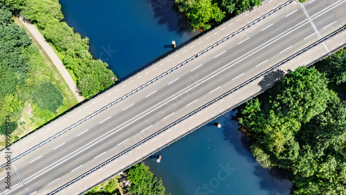 Aerial drone view of bridge over river, forest landscape and modern road bridge, transportation and infrastructure concept, the Netherlands