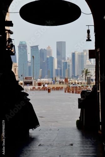 Dark view from old market souk looking across to modern Doha, Qatar