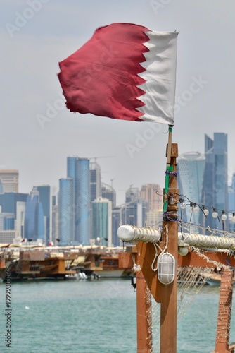 Ragged Qatar flag flies proudly in Doha