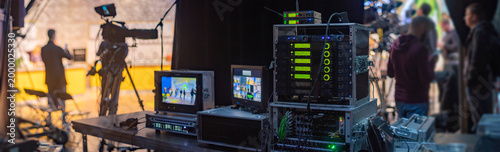 Professional Broadcast Control Room Setup with Server Racks and Staff with Copy Space