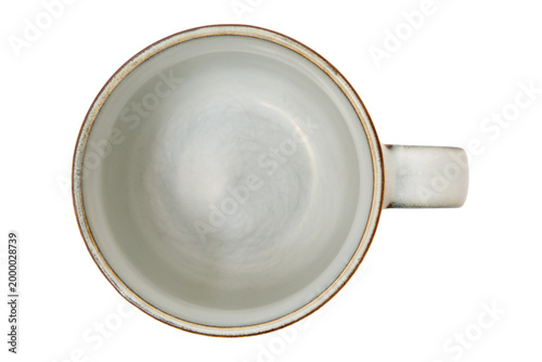 Empty ceramic mug viewed from above on transparent background. Stoneware cup for hot beverage. Kitchenware and utensil for tea or coffee drinking concept. Minimalist rustic dining accessory.