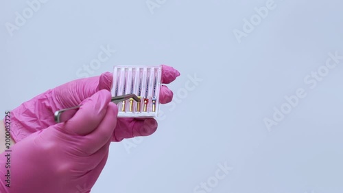 Dental Assistant Organizing Root Canal Instruments in Sterilization Box