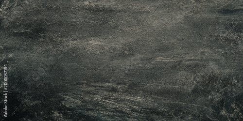 Dark gray wall scratched and distressed texture background with rough surface