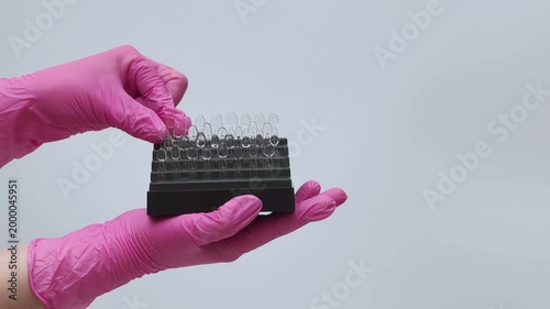 Dental Shade Guide Held by Technician in Gloves
