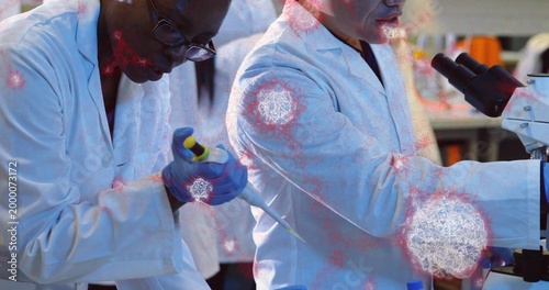 Pipetting scientist wearing white coat gloves moving sample at lab bench with pipette, microscope