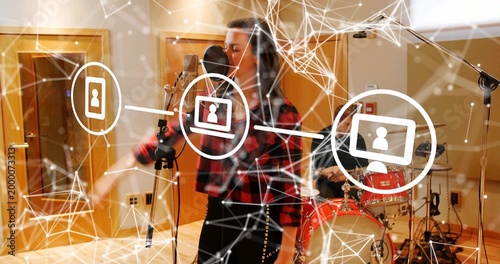 Singing singer in studded skirt gesturing and recording in studio with mic and network overlay