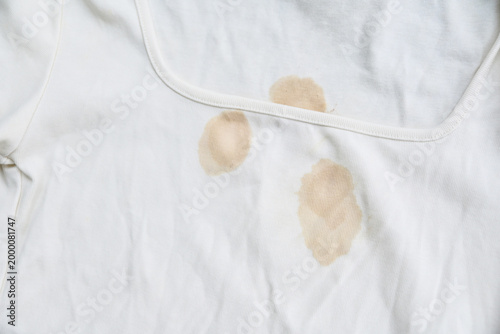 Photos dirty yellow stains on a white rib-knit sleeveless shirt