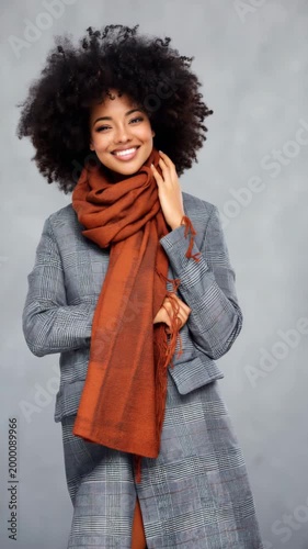 African female young adult orange scarf gray coat three quarter portrait warm accessory stylish smile