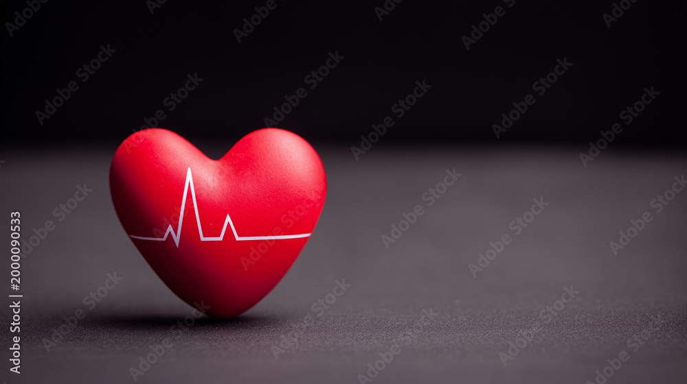 Fototapeta premium Red heart with a heartbeat EKG line on a dark background with copy space