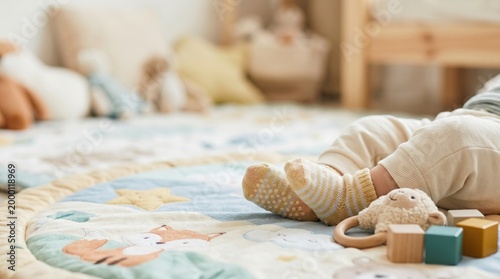 Baby's feet with socks and toys on a playmat