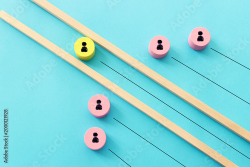 Wooden cubes with people icons over pastel background, human resources and management concept