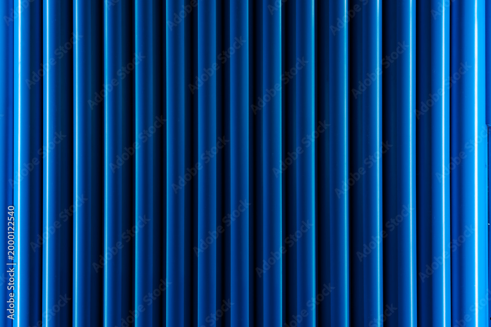 Fototapeta premium a metallic texture with a vertical line pattern, which is commonly used as a background texture or for decorative wall panels