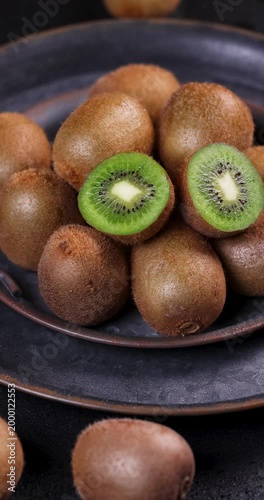 Fresh ripe kiwi fruits rotating on plate
