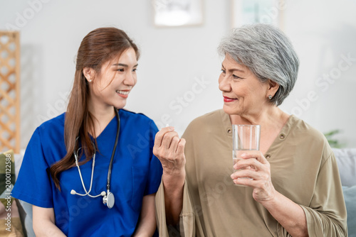 Asian caregiver give consultant to senior woman patient at nursing home. 
