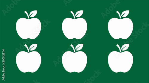 White apple icons on green background illustrating healthy food and nature