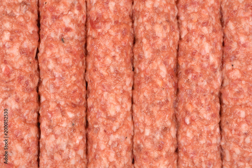 Fotografie A close up shot of raw cevapcici sausages made from seasoned minced meat arrange