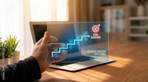 Business success and growth strategy concept with hand holding digital screen showing kpi achievement target and progress chart for professional development and corporate goal management.