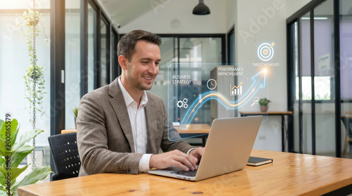 Successful businessman working on laptop with digital hologram showing business growth strategy target kpi and achievement goals for corporate financial success in modern office environment.