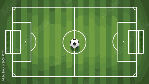 Overhead view of a green soccer field with white markings and a single football placed at the center kick off point for a competitive game.