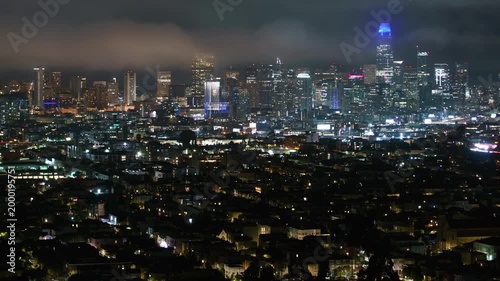 San Francisco Downtown Foggy Skyline from Bernal Heights Night Time Lapse Pan R California USA