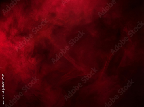 Foto Intense deep red smoke swirling against a stark black background, creating an abstract and moody texture