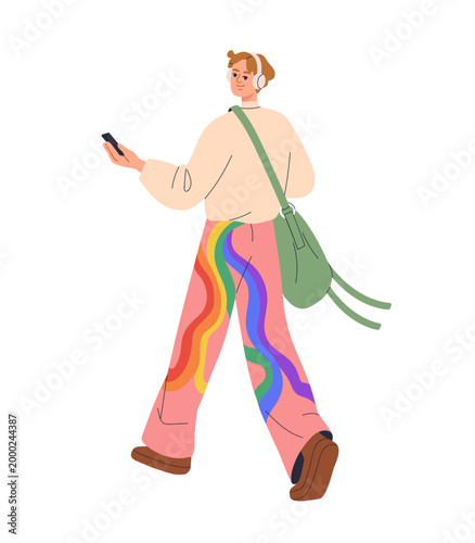 Young man walking outdoors, holding mobile phone, modern style outfit with ra...