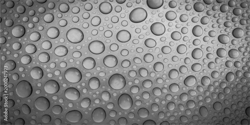 Macro shot of a textured surface covered in a multitude of water droplets, showcasing detail and contrast. 
