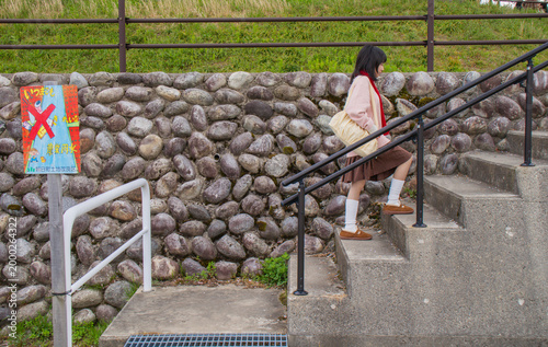 Schoolgirl Climbing Stairs Outdoors