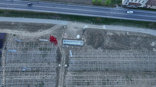 Drone footage captures the ongoing construction of a large solar power plant in the Po Valley region of Italy during the golden hour