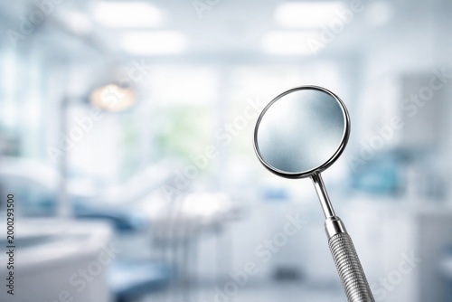 Close examination dental mirror image against diffused healthcare environment backdrop with copy space
