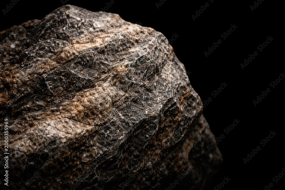 Fototapeta premium Fine textures of a natural rock contrasted with a pure black background