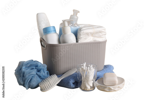 Photos Bathroom storage basket with toiletries towels and loofah, bath accessories isol